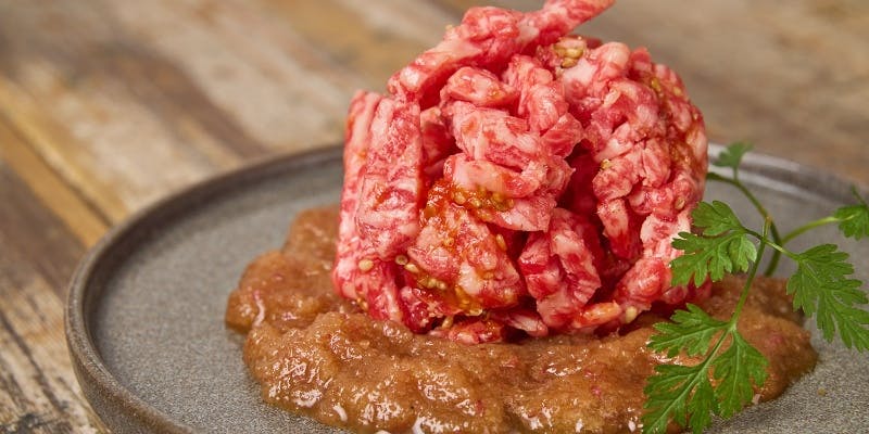 器に盛られたユッケ肉とすりおろしりんご